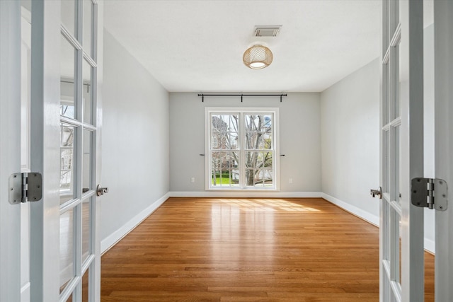 2108 Branard St, Houston, TX 77098 - spare room with french doors, wood finished floors, and baseboards