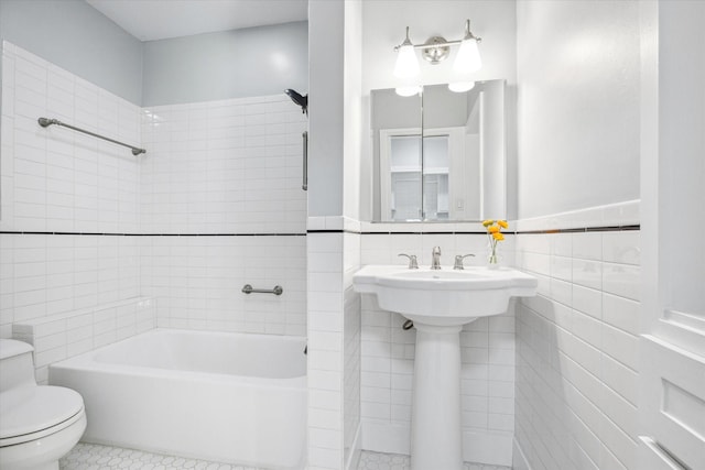 2108 Branard St, Houston, TX 77098 - bathroom with tile walls, toilet, tile patterned flooring, shower / tub combination, and wainscoting
