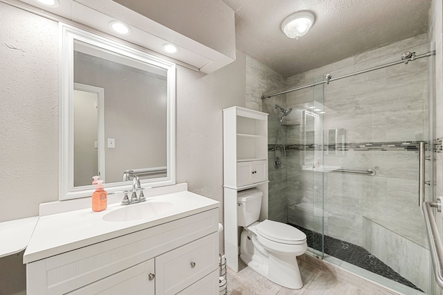 1343 Somercotes Ln, Channelview, TX 77530 - bathroom with toilet, a shower stall, vanity, and a textured wall