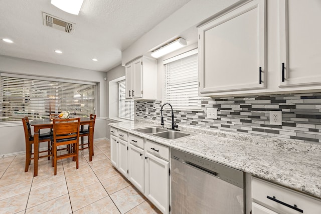 1343 Somercotes Ln, Channelview, TX 77530 - kitchen with stainless steel dishwasher, a sink, backsplash, baseboards, and light tile patterned floors