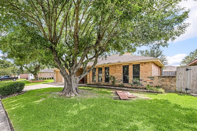 1343 Somercotes Ln, Channelview, TX 77530 - view of front of home with concrete driveway, brick siding, an attached garage, and roof with shingles