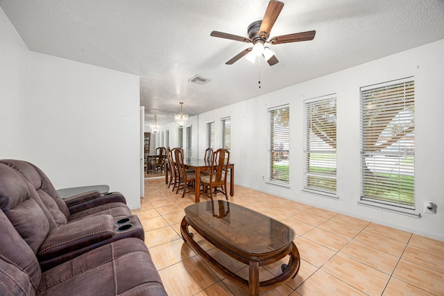 1343 Somercotes Ln, Channelview, TX 77530 - living area featuring a textured ceiling, light tile patterned floors, and ceiling fan