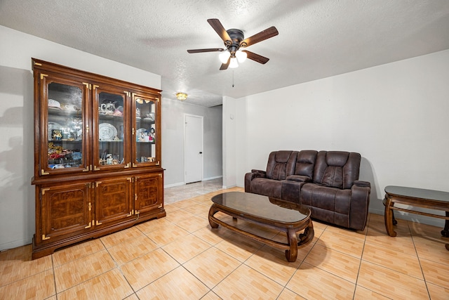 1343 Somercotes Ln, Channelview, TX 77530 - living room with a ceiling fan, light tile patterned floors, a textured ceiling, and baseboards