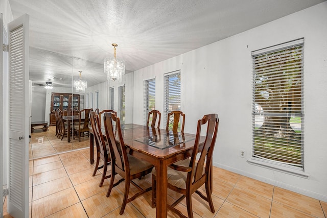 1343 Somercotes Ln, Channelview, TX 77530 - dining room with light tile patterned flooring, a chandelier, baseboards, and a textured ceiling