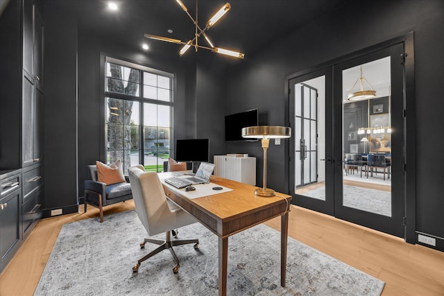 510 Wilmington Dr, Bellaire, TX 77401 - office with french doors, light wood-style floors, a chandelier, and a high ceiling