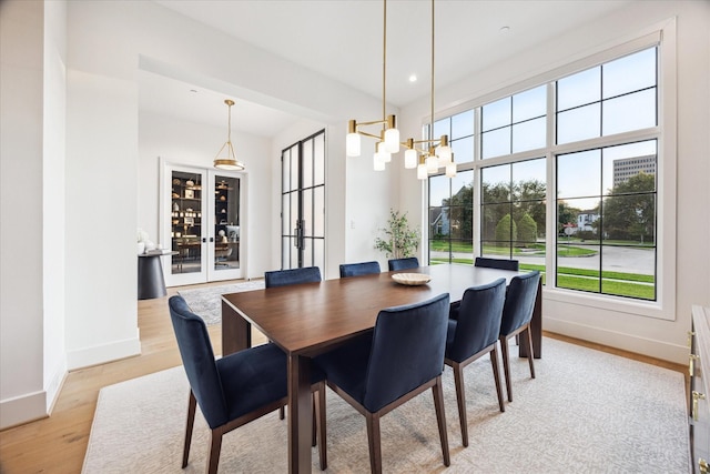 510 Wilmington Dr, Bellaire, TX 77401 - dining space featuring baseboards, light wood-style floors, a chandelier, french doors, and recessed lighting