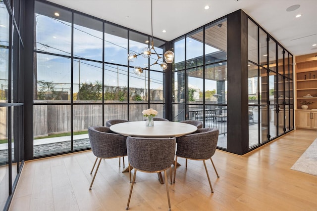 510 Wilmington Dr, Bellaire, TX 77401 - dining space with expansive windows, wood finished floors, plenty of natural light, and a chandelier