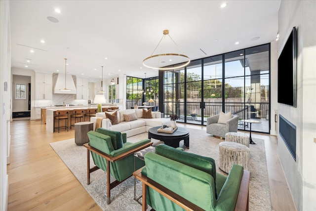 510 Wilmington Dr, Bellaire, TX 77401 - living area with plenty of natural light, light wood-style floors, recessed lighting, floor to ceiling windows, and a fireplace