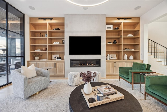 510 Wilmington Dr, Bellaire, TX 77401 - living area featuring stairs, a glass covered fireplace, floor to ceiling windows, and built in shelves