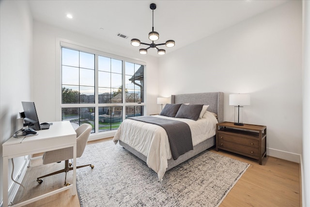 510 Wilmington Dr, Bellaire, TX 77401 - bedroom featuring light wood-type flooring, a chandelier, a desk, and baseboards