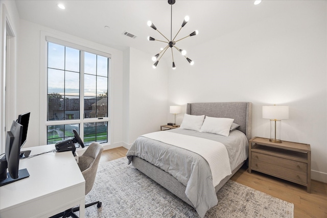 510 Wilmington Dr, Bellaire, TX 77401 - bedroom with a chandelier, light wood finished floors, a desk, recessed lighting, and baseboards