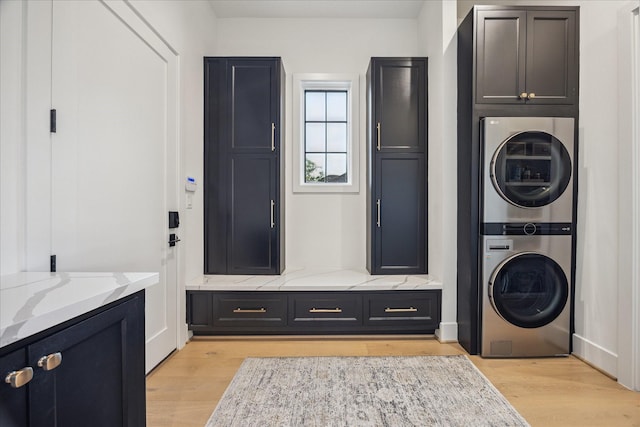510 Wilmington Dr, Bellaire, TX 77401 - laundry area featuring estacked washer and dryer, cabinet space, and light wood finished floors
