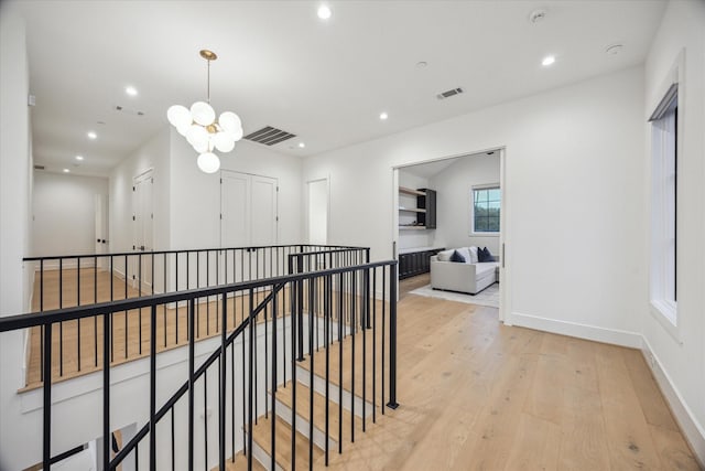 510 Wilmington Dr, Bellaire, TX 77401 - hall featuring recessed lighting, wood finished floors, a chandelier, an upstairs landing, and baseboards