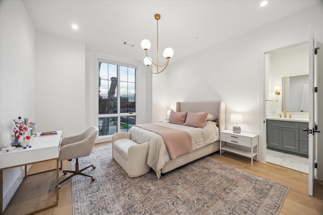 510 Wilmington Dr, Bellaire, TX 77401 - bedroom with light wood-style floors, a sink, ensuite bathroom, a desk, and recessed lighting