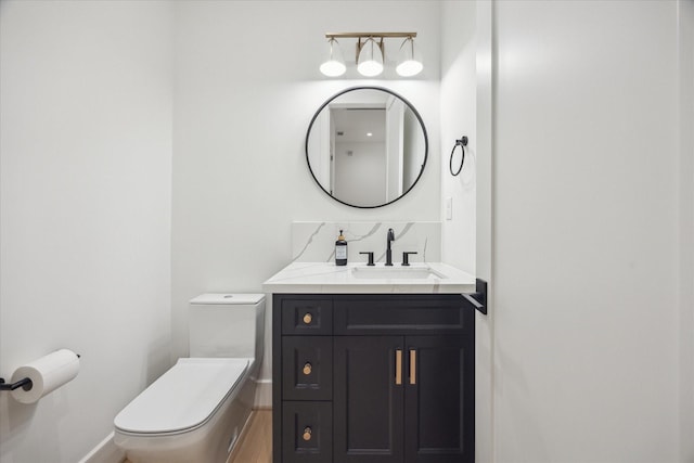 510 Wilmington Dr, Bellaire, TX 77401 - bathroom featuring toilet, vanity, baseboards, and wood finished floors