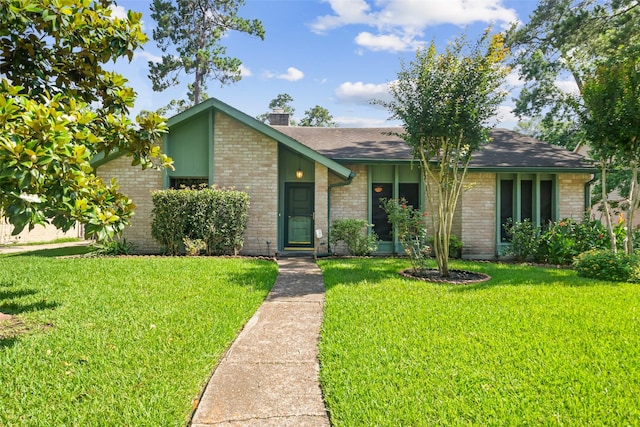 3811 Riverwood Park Dr, Houston, TX 77345 - mid-century modern home with a front lawn, brick siding, and a chimney