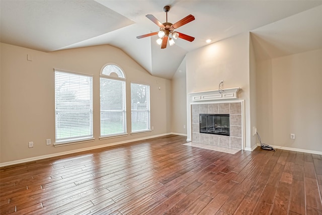 11519 Staffordale Ct, Cypress, TX 77433 - unfurnished living room with a ceiling fan, plenty of natural light, wood finished floors, a fireplace, and vaulted ceiling
