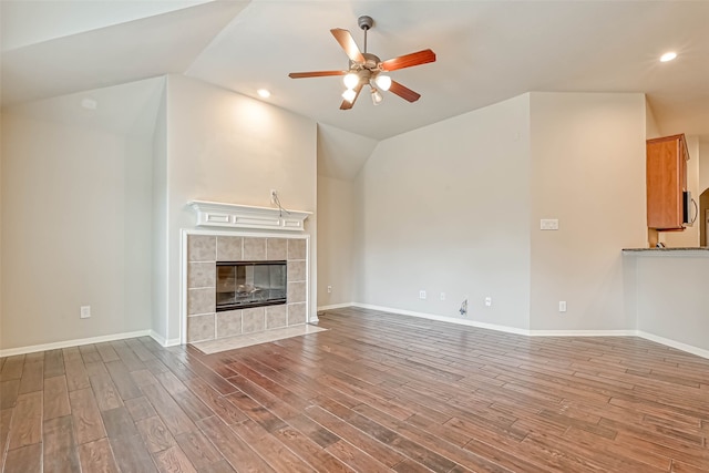 11519 Staffordale Ct, Cypress, TX 77433 - unfurnished living room featuring lofted ceiling, ceiling fan, wood finished floors, a fireplace, and baseboards