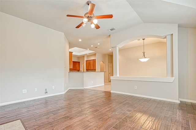 11519 Staffordale Ct, Cypress, TX 77433 - unfurnished living room with arched walkways, light wood-style flooring, a ceiling fan, baseboards, and recessed lighting