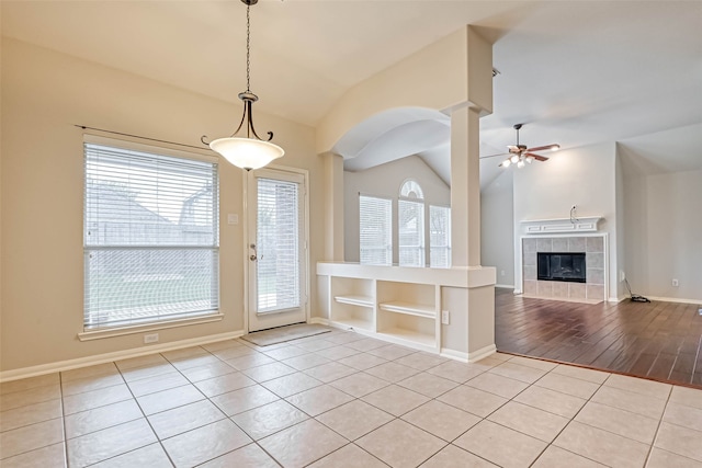 11519 Staffordale Ct, Cypress, TX 77433 - foyer entrance featuring vaulted ceiling, ceiling fan, light tile patterned flooring, a fireplace, and baseboards
