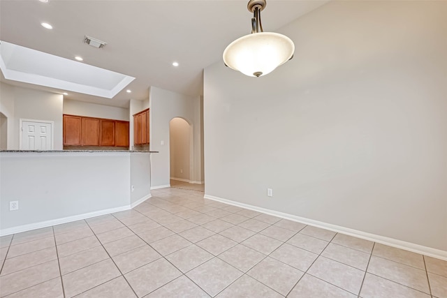11519 Staffordale Ct, Cypress, TX 77433 - unfurnished room featuring arched walkways, light tile patterned flooring, recessed lighting, baseboards, and a raised ceiling
