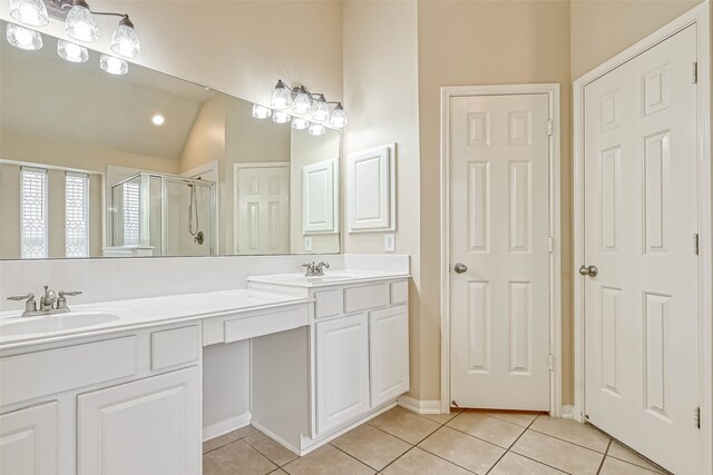 11519 Staffordale Ct, Cypress, TX 77433 - bathroom with tile patterned floors, a shower stall, double vanity, and vaulted ceiling