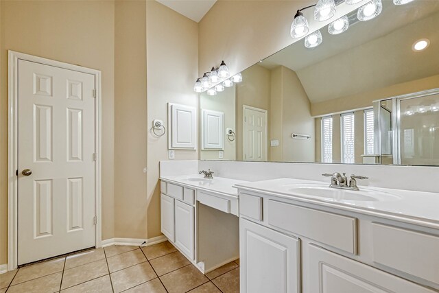 11519 Staffordale Ct, Cypress, TX 77433 - bathroom featuring double vanity, tile patterned flooring, a shower stall, lofted ceiling, and baseboards