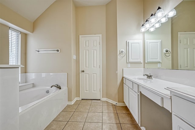 11519 Staffordale Ct, Cypress, TX 77433 - bathroom featuring vanity, a garden tub, tile patterned flooring, lofted ceiling, and baseboards