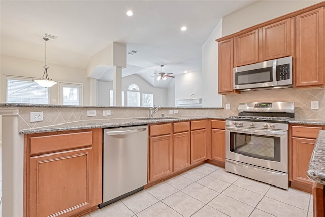 11519 Staffordale Ct, Cypress, TX 77433 - kitchen with stainless steel appliances, a sink, ceiling fan, backsplash, and light stone countertops