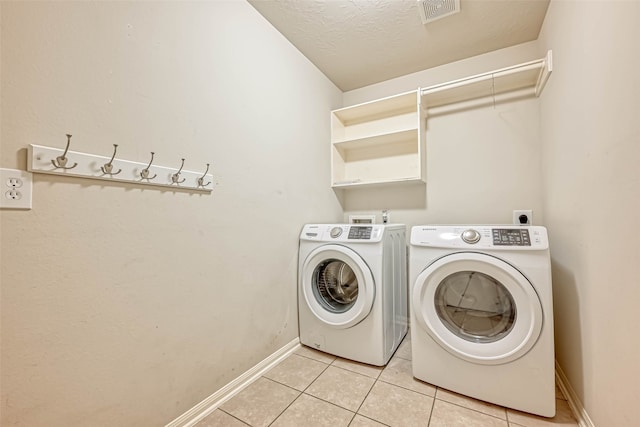 11519 Staffordale Ct, Cypress, TX 77433 - laundry room featuring light tile patterned floors, baseboards, and washer and dryer