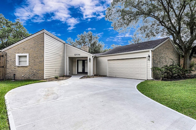12014 Briar Forest Dr, Houston, TX 77077 - mid-century home featuring french doors, driveway, a garage, a chimney, and stone siding
