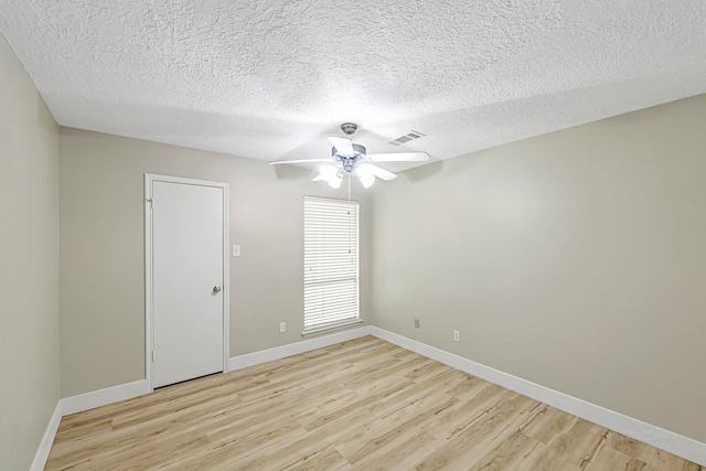12014 Briar Forest Dr, Houston, TX 77077 - unfurnished room with light wood-type flooring, ceiling fan, baseboards, and a textured ceiling