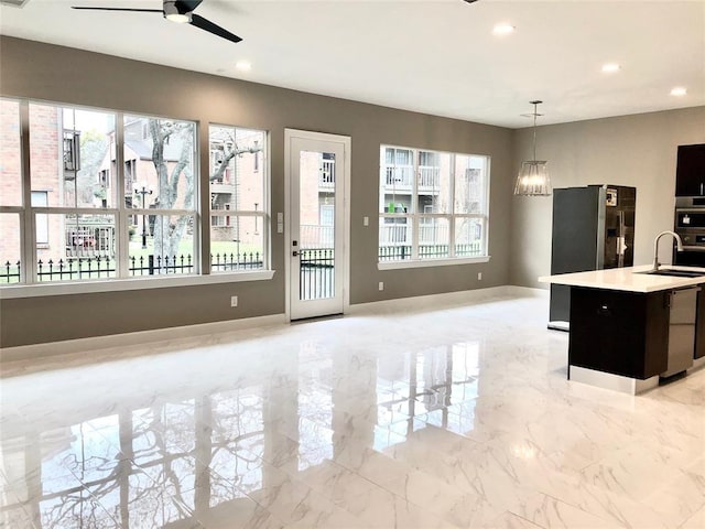 1920 Pueblo Nuevo Path, Houston, TX 77077 - kitchen featuring a ceiling fan, light countertops, plenty of natural light, recessed lighting, and hanging light fixtures