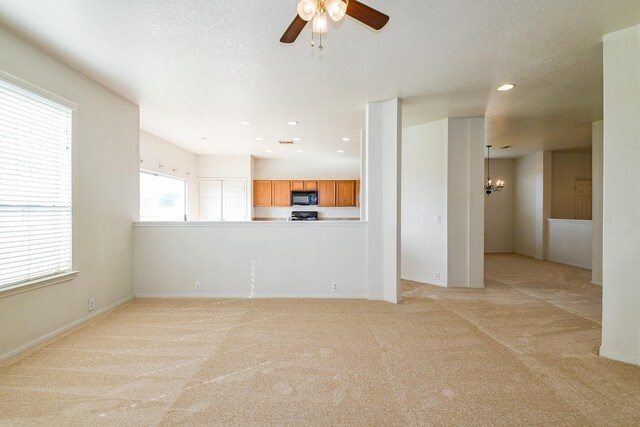 3043 Feather Green Trl, Fresno, TX 77545 - unfurnished living room featuring a chandelier, light colored carpet, a ceiling fan, and recessed lighting