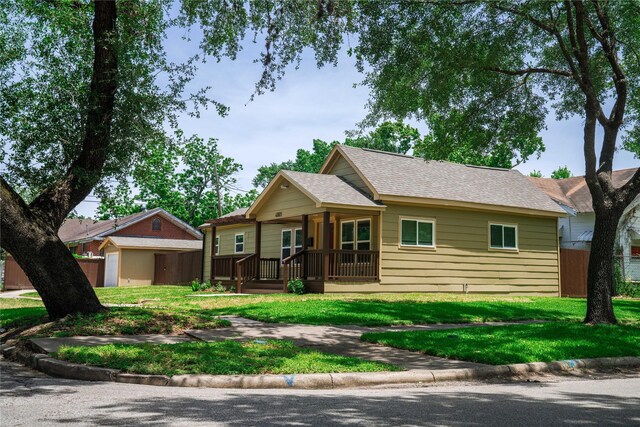4801 Walker St, Houston, TX 77023 - single story home featuring a porch, a front lawn, and a shingled roof