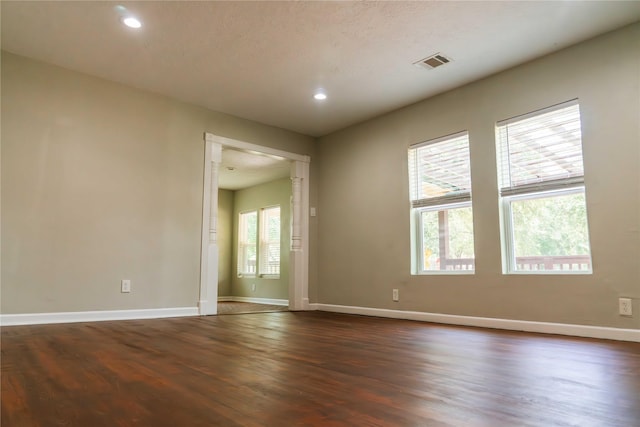 4801 Walker St, Houston, TX 77023 - spare room with dark wood finished floors, baseboards, and recessed lighting