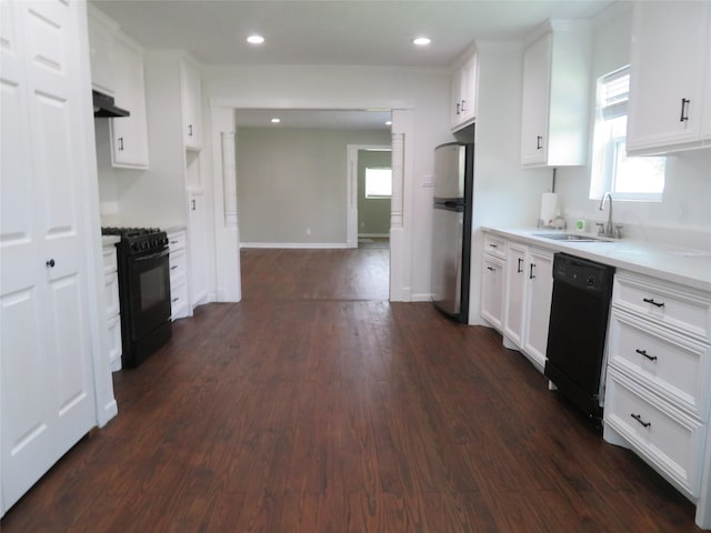 4801 Walker St, Houston, TX 77023 - kitchen with black appliances, a sink, dark wood-type flooring, light countertops, and recessed lighting