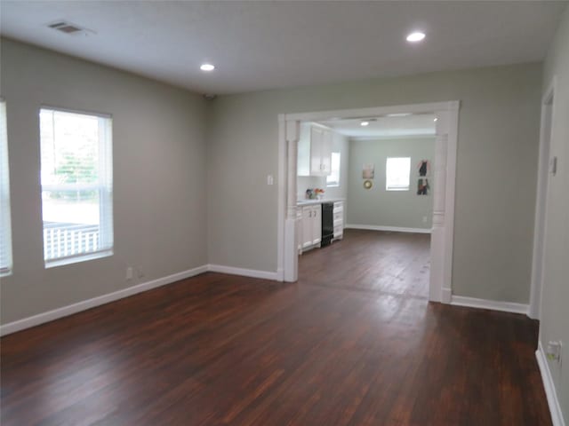 4801 Walker St, Houston, TX 77023 - unfurnished living room featuring dark wood-type flooring, baseboards, and recessed lighting