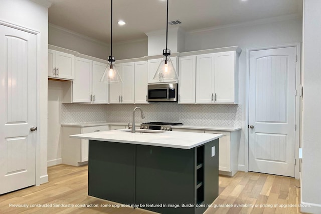 833 Fisher St Unit C, Houston, TX 77018 - kitchen featuring stainless steel microwave, a sink, white cabinets, crown molding, and light wood-style floors