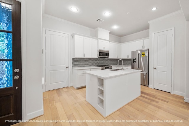 833 Fisher St Unit C, Houston, TX 77018 - kitchen with appliances with stainless steel finishes, a sink, ornamental molding, light wood-style flooring, and decorative backsplash