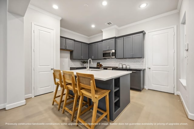 833 Fisher St Unit C, Houston, TX 77018 - kitchen featuring stainless steel microwave, recessed lighting, a kitchen island with sink, decorative backsplash, and light countertops