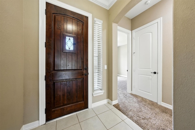 4914 Fairford Dr, Sugar Land, TX 77479 - entrance foyer featuring arched walkways, light tile patterned floors, light carpet, and crown molding