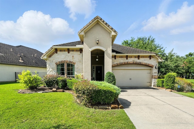 4914 Fairford Dr, Sugar Land, TX 77479 - view of front of house with stone siding, an attached garage, concrete driveway, and a front yard