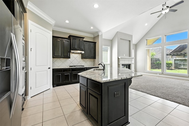 4914 Fairford Dr, Sugar Land, TX 77479 - kitchen with stainless steel fridge with ice dispenser, open floor plan, light tile patterned floors, black cooktop, and recessed lighting