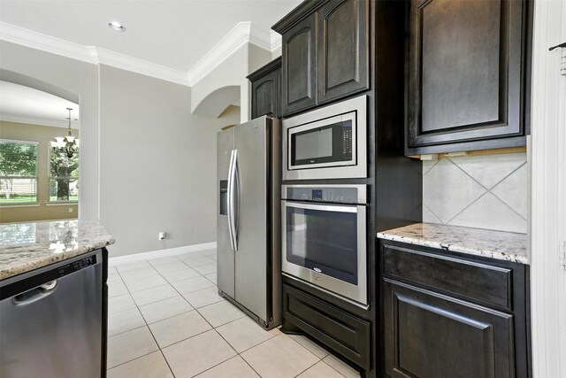 4914 Fairford Dr, Sugar Land, TX 77479 - kitchen featuring appliances with stainless steel finishes, crown molding, a chandelier, tasteful backsplash, and light stone countertops