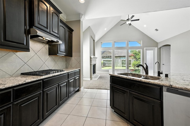 4914 Fairford Dr, Sugar Land, TX 77479 - kitchen with appliances with stainless steel finishes, under cabinet range hood, ceiling fan, light stone counters, and arched walkways