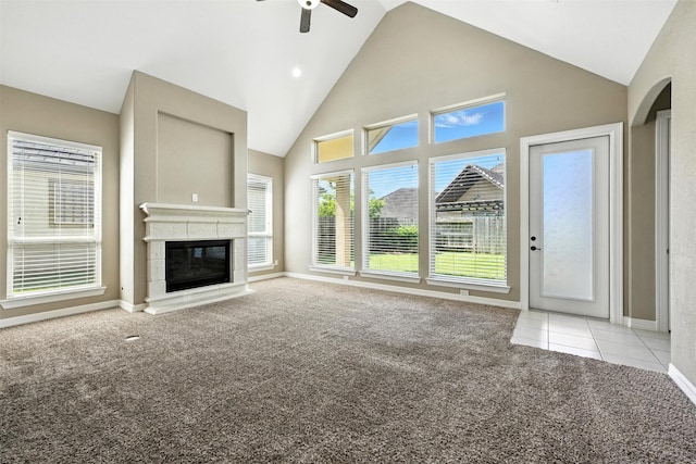 4914 Fairford Dr, Sugar Land, TX 77479 - unfurnished living room with light colored carpet, a ceiling fan, high vaulted ceiling, a glass covered fireplace, and light tile patterned floors