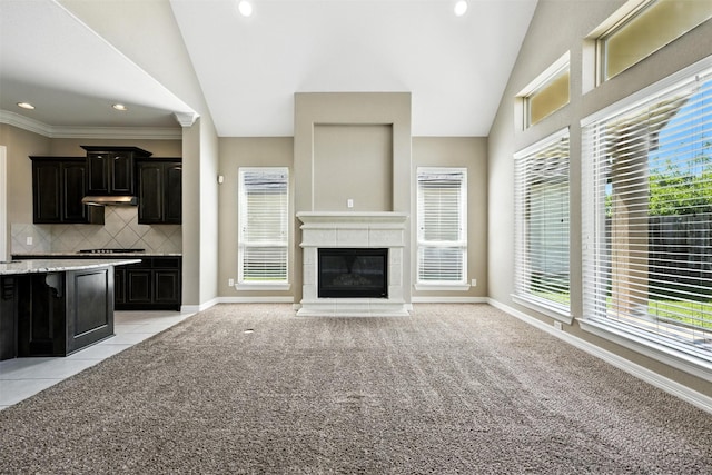 4914 Fairford Dr, Sugar Land, TX 77479 - unfurnished living room with vaulted ceiling, light carpet, healthy amount of natural light, recessed lighting, and a tiled fireplace