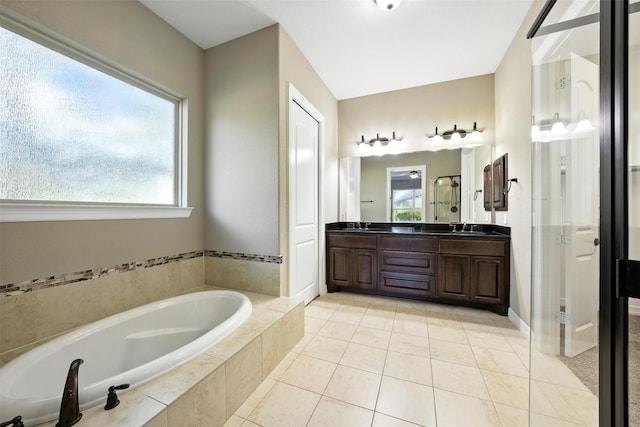 4914 Fairford Dr, Sugar Land, TX 77479 - bathroom with double vanity, a bath, tile patterned floors, and healthy amount of natural light