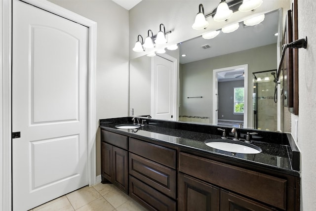 4914 Fairford Dr, Sugar Land, TX 77479 - bathroom featuring double vanity, a tile shower, and tile patterned floors